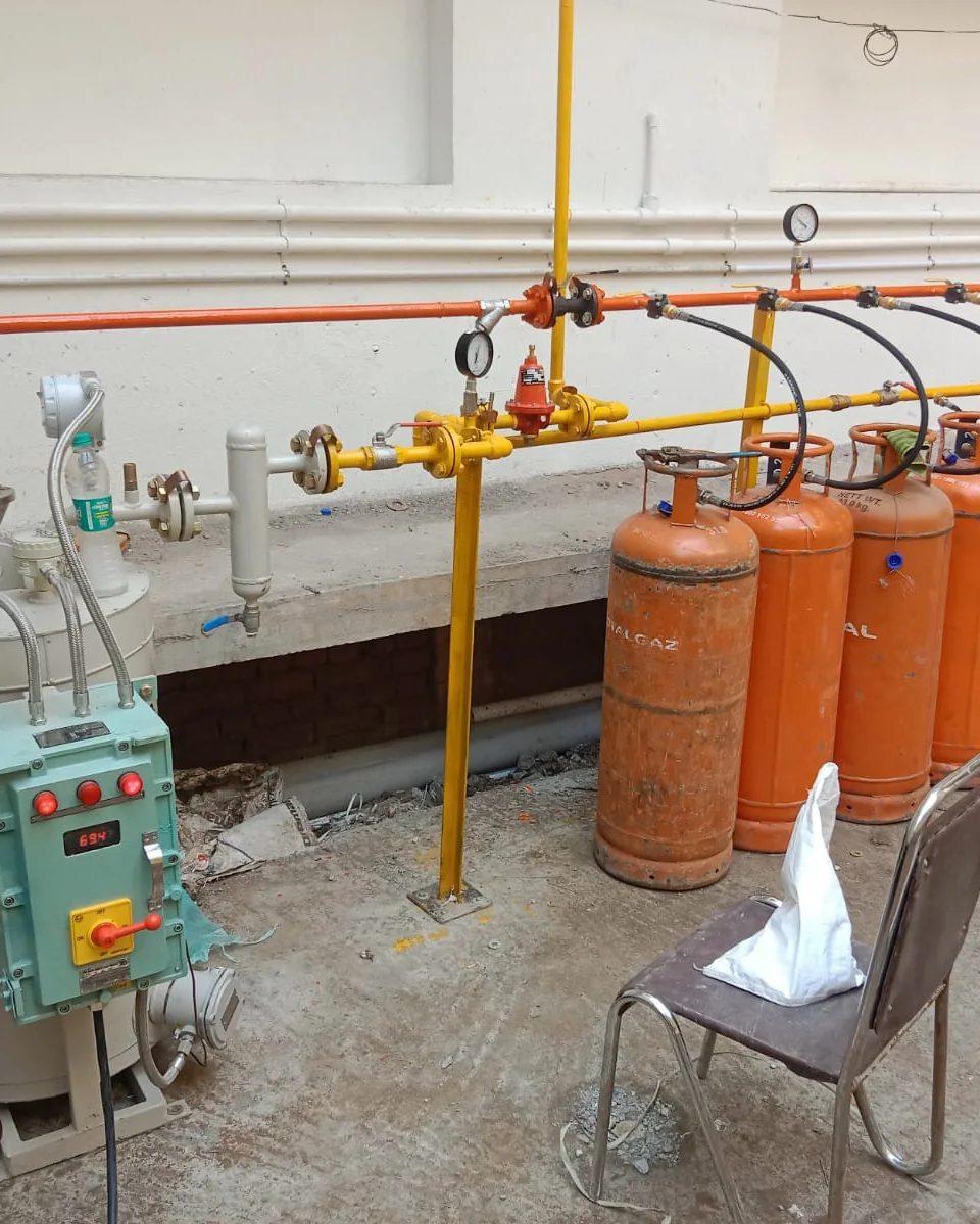 Industrial gas manifold with pressure regulator, gauges, bulk LPG cylinders, and an electronic control panel installed by Bisarre Solutions