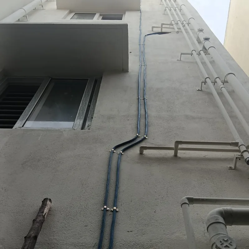 Copper gas pipeline riser installed on the exterior wall of a residential building