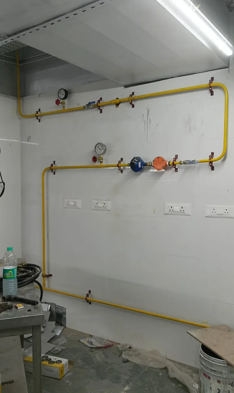 Gas pipeline manifold with pressure gauges and a regulator installed in a hotel kitchen