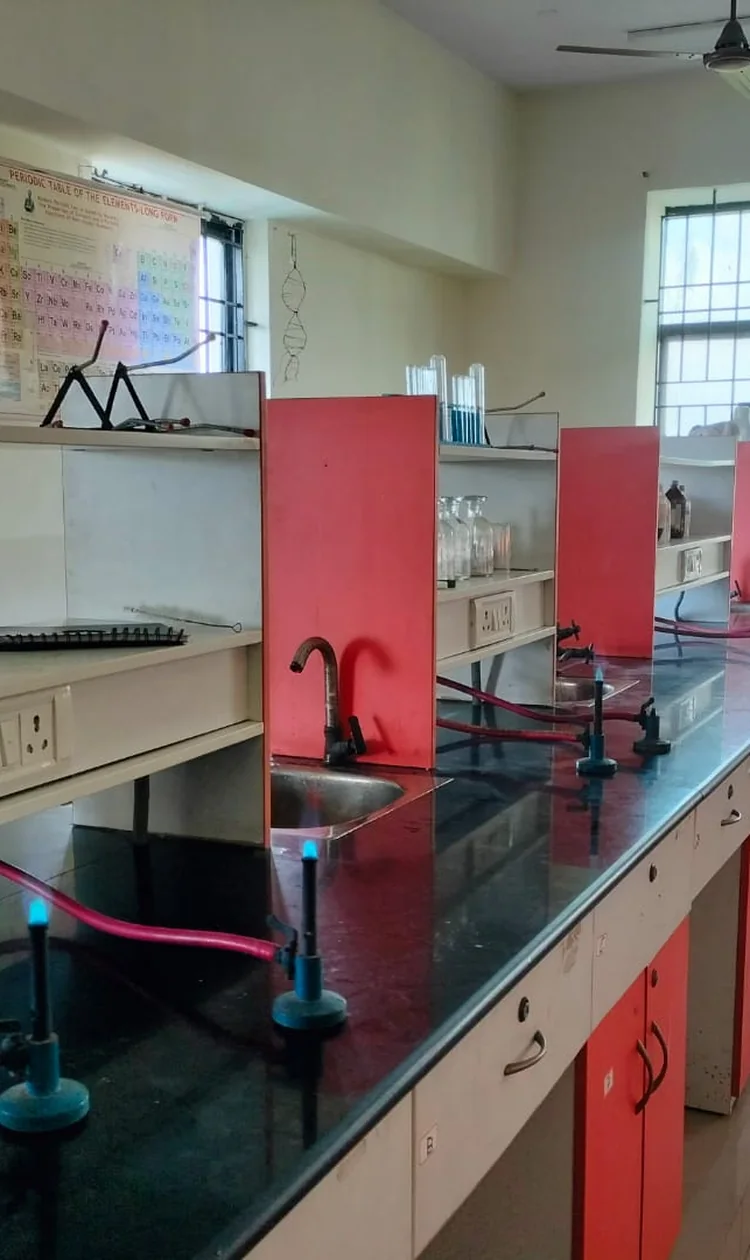 School chemistry laboratory workbenches with lit Bunsen burners connected to the gas pipeline